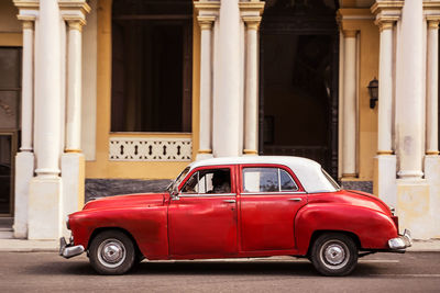 Vintage car on street against building