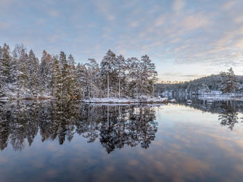 Lake in wilderness winter time at sunset with dramatic sky