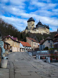 Buildings in town against sky