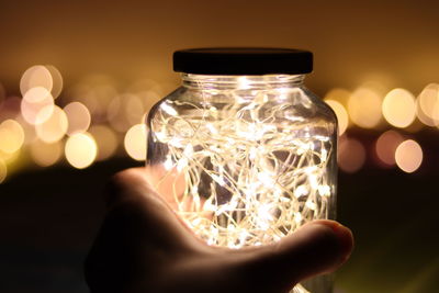 Close-up of hand holding illuminated light
