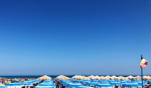 Panoramic view of buildings and sea against clear blue sky