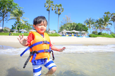 Portrait of boy standing at beach