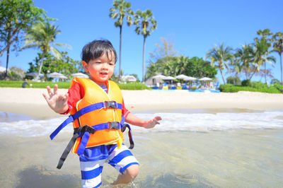 Portrait of boy standing at beach