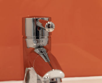 Close-up of faucet against wall