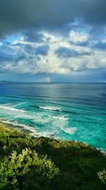 Scenic view of sea against cloudy sky