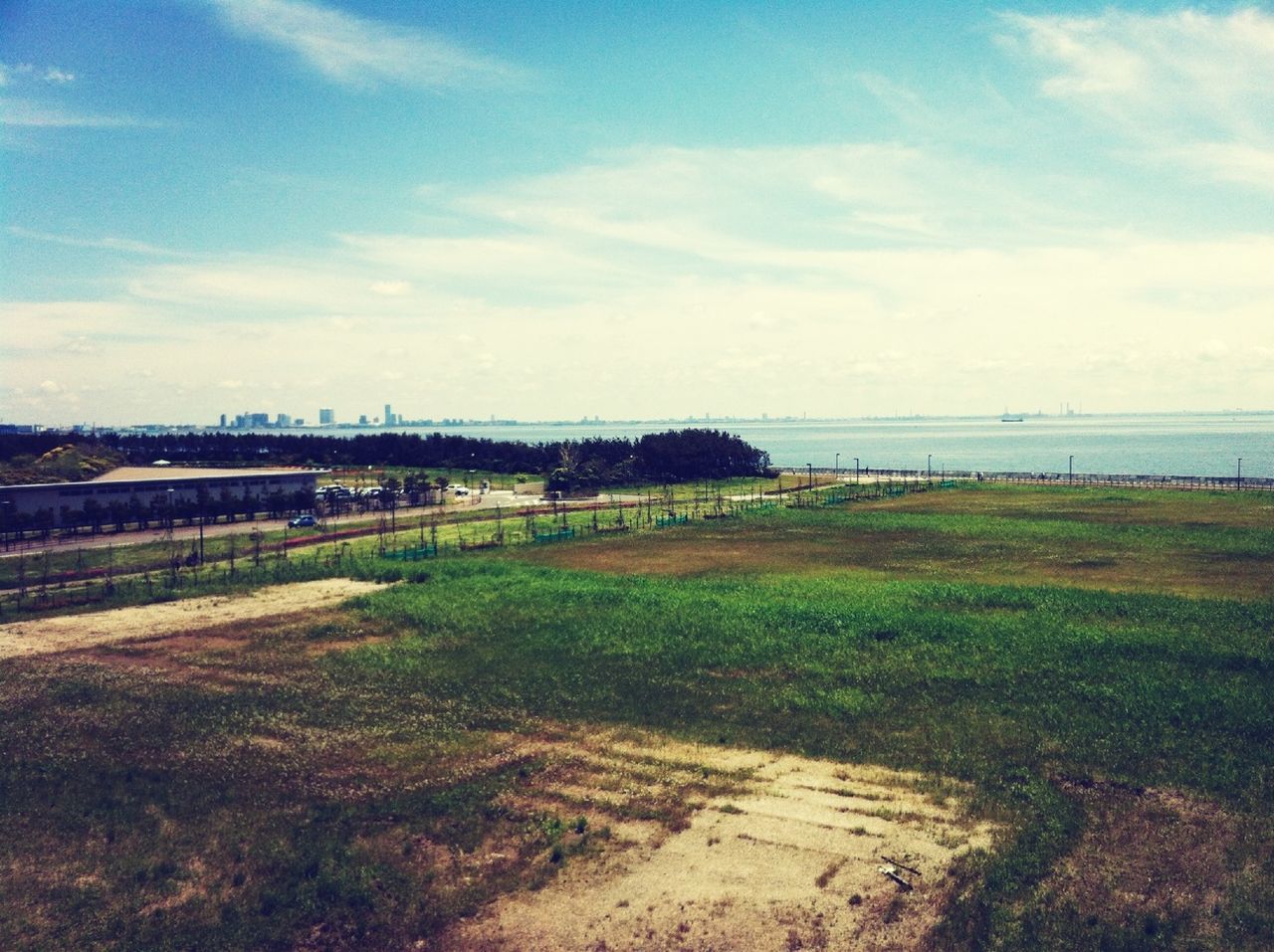 sky, sea, grass, horizon over water, water, tranquil scene, tranquility, scenics, cloud - sky, beach, nature, beauty in nature, cloud, shore, day, landscape, cloudy, idyllic, field, remote