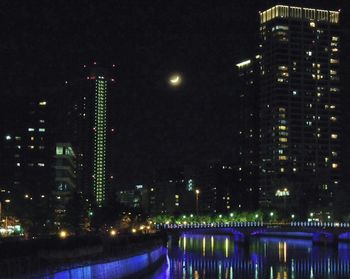 Illuminated buildings in city at night