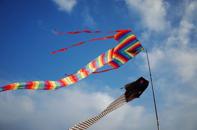 Low angle view of flags hanging against sky