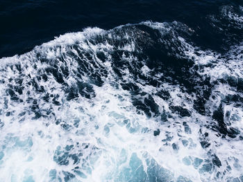 High angle view of waves splashing in sea