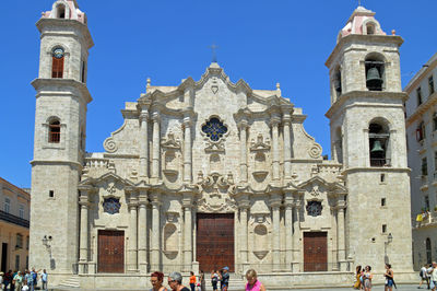 Group of people in front of building against sky