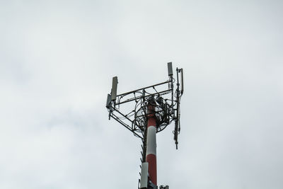 Low angle view of communications tower against sky