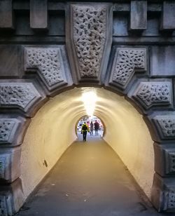 People walking in corridor of building