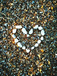 Directly above shot of heart shape stone on beach