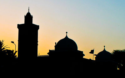Silhouette of church against sky at sunset
