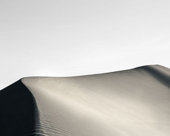 View of sand dunes against sky