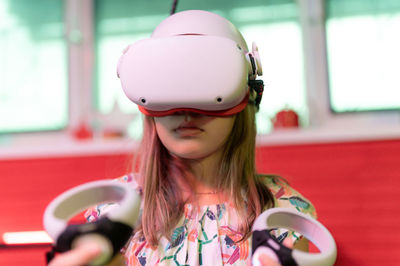 Vr game and virtual reality. kid girl gamer fun playing on futuristic simulation video shooting game