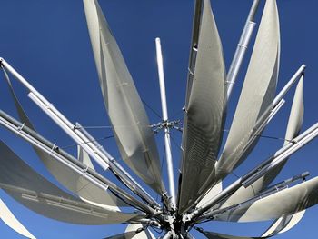 Low angle view of crane against blue sky