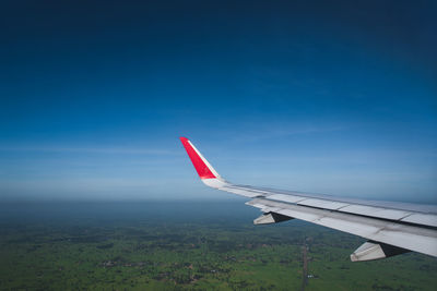 Airplane flying over blue sky