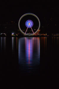 Illuminated ferris wheel at night