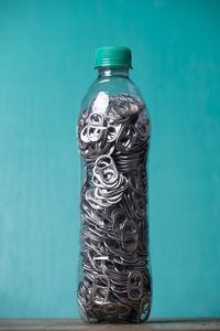 Close-up of glass bottle against blue background