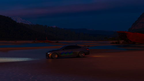 Vintage car on mountain against sky at night