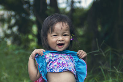 Portrait of cute girl sitting outdoors