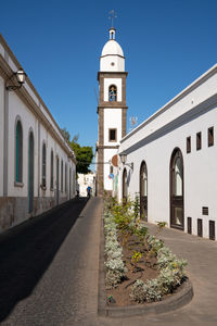 Street amidst buildings against sky in city