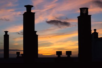 Silhouette tower against sky during sunset