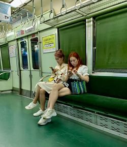 Portrait of smiling woman sitting in train