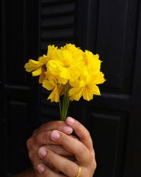 Close-up of hand holding flower bouquet
