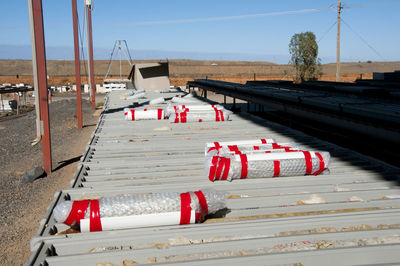 Deck chairs on red against sky