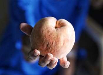 Midsection of woman holding fruit