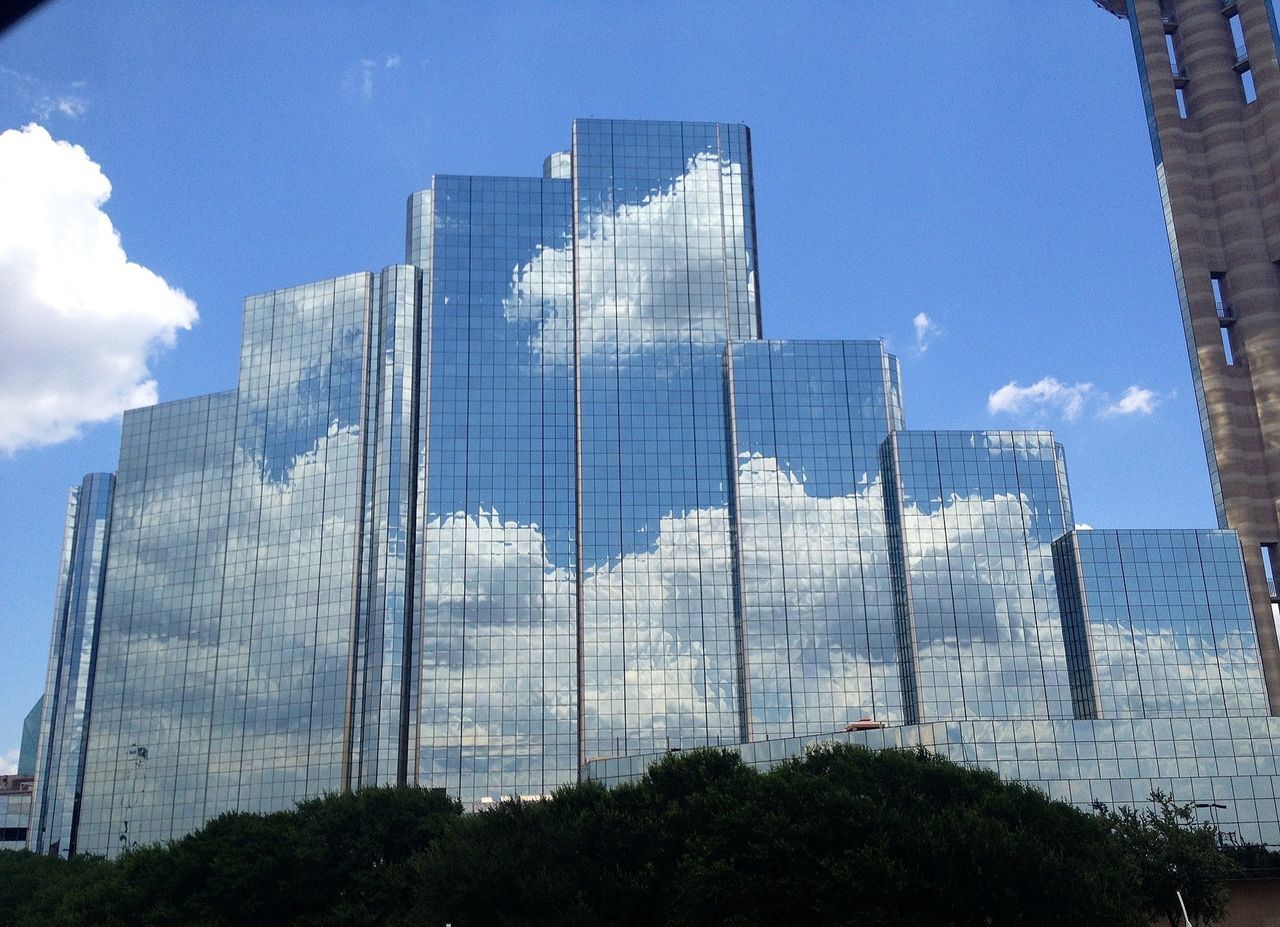 building exterior, architecture, built structure, low angle view, sky, modern, office building, skyscraper, tall - high, city, tower, building, animal themes, cloud - sky, day, glass - material, outdoors, cloud, no people, blue