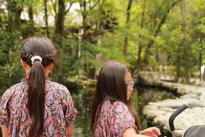 Rear view of women sitting in park