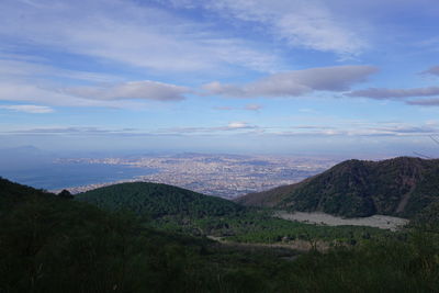 View of cityscape against cloudy sky