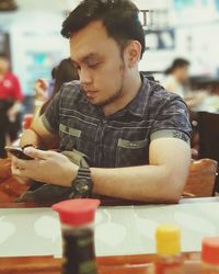 Young man looking at restaurant