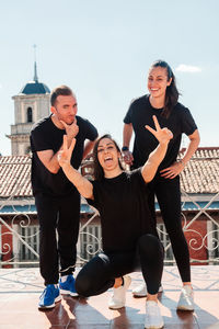 Fitness equipment of three young women on a terrace looking at the camera