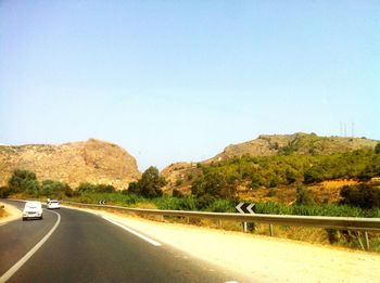 Country road against clear sky