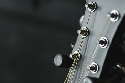 Close-up of guitar against black background