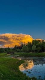 Scenic view of lake at sunset