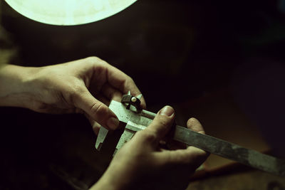 Cropped image of worker holding vernier calliper