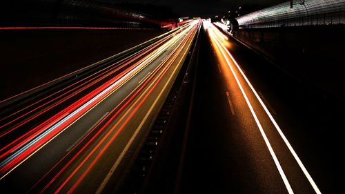 High angle view of light trails on highway at night