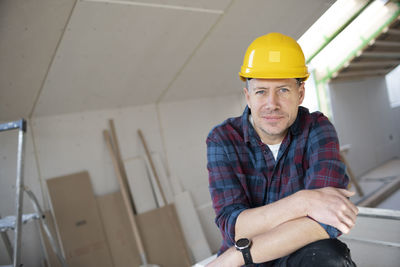Portrait of young man working at construction site