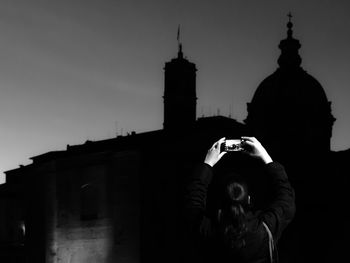 Man in city against sky at night