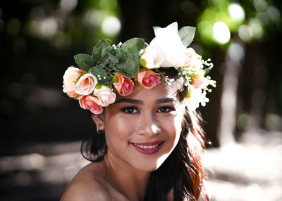 Portrait of beautiful woman with red flower