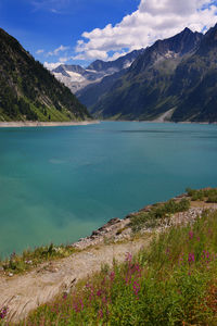 Scenic view of lake and mountains against sky