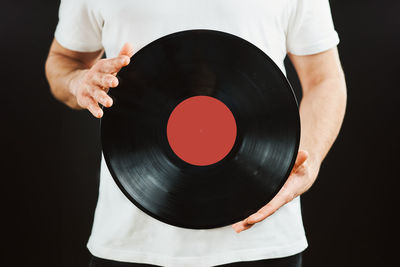 Playing music from vinyl record. vintage and retro. man holding analog record. classic audio. mockup