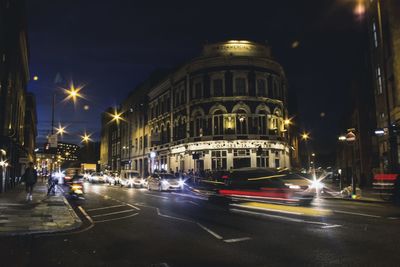 Cars on city street at night