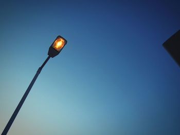 Low angle view of street light against clear blue sky