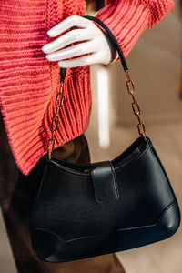 Classic black leather women's handbag with gold chain. fashion details and accessories